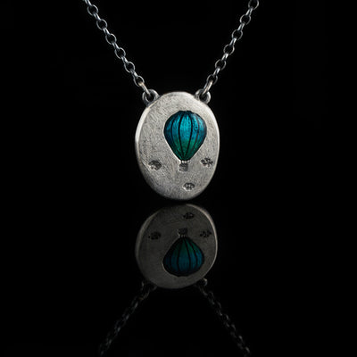 silver hot air balloon pendant with turquoise colored cold enamel