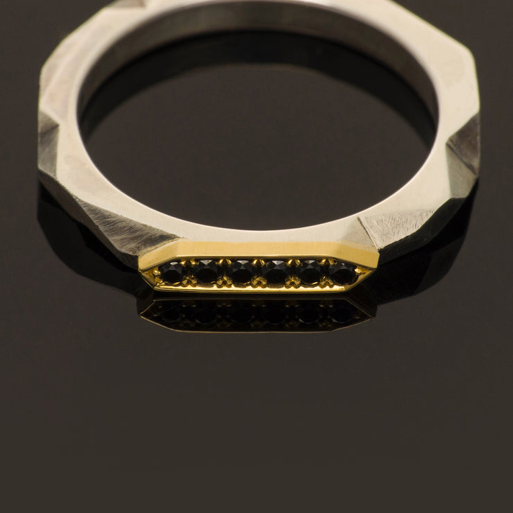 silver and gold band with black diamonds