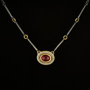 Halo necklace with garnet